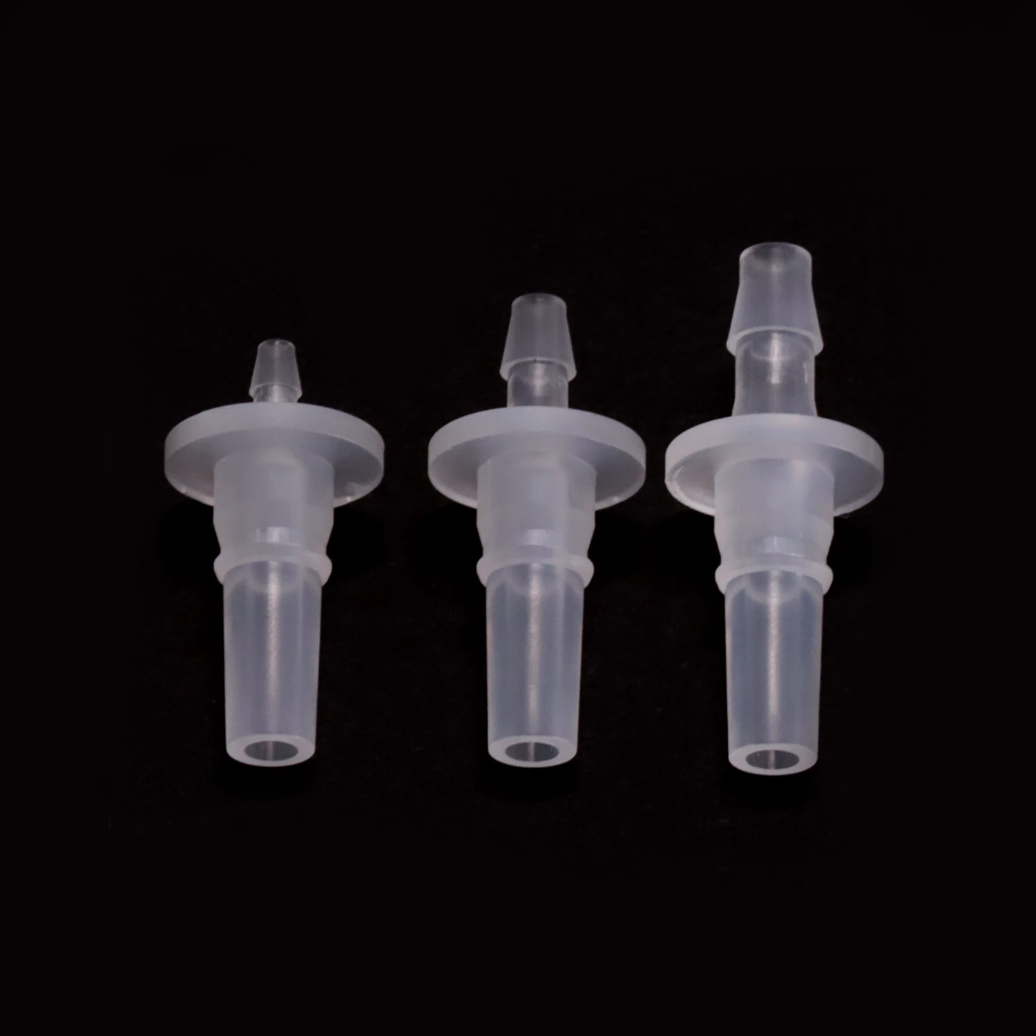 LRL rotating male Luer cores in natural PP, three hose barb sizes shown together